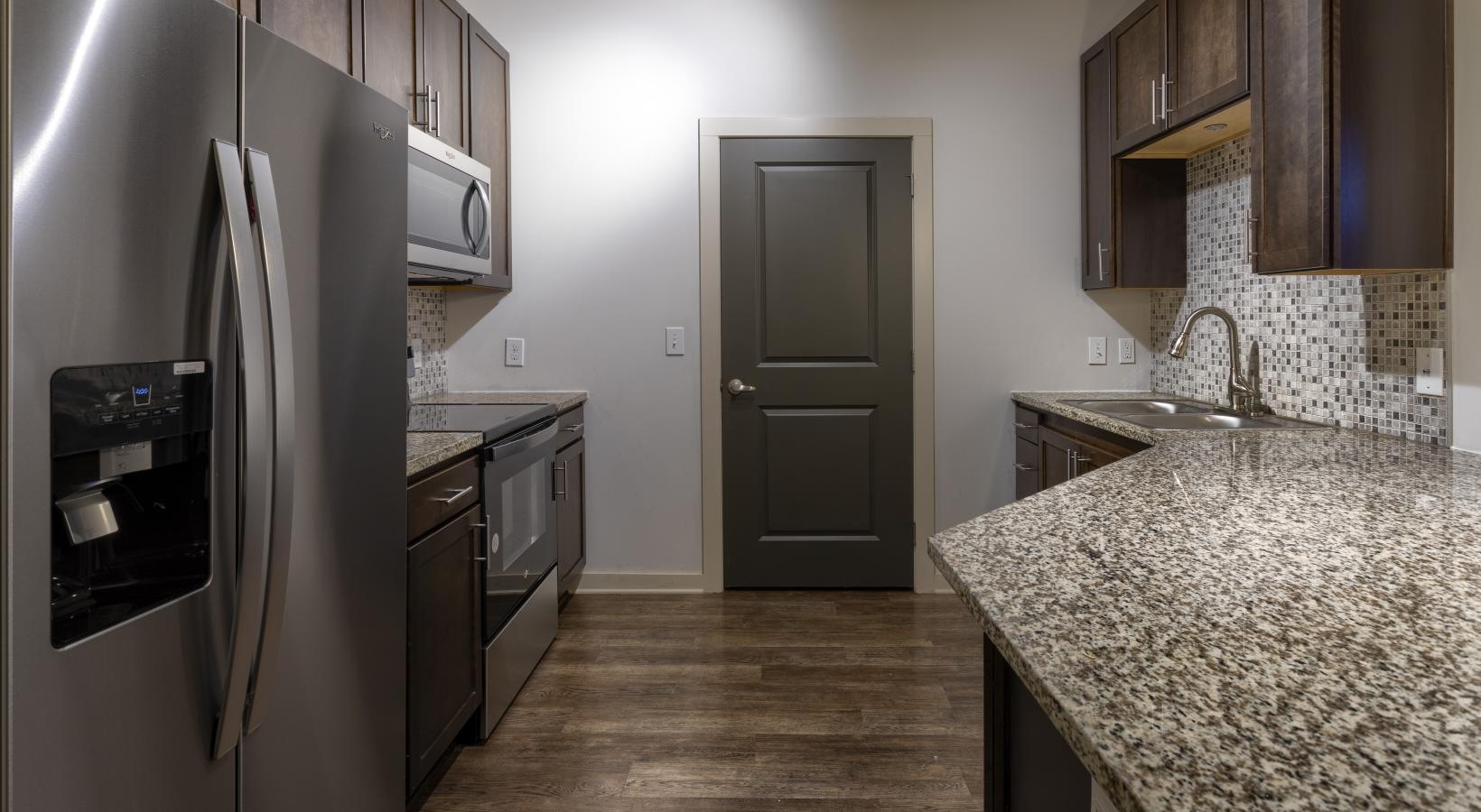 Spacious kitchens with thoughtful details a kitchen with a stainless steel refrigerator