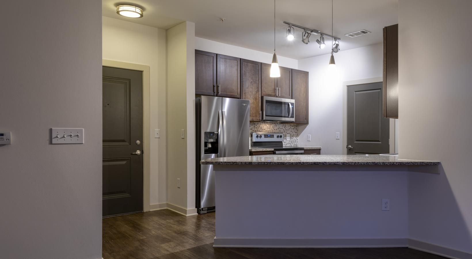 Settle into comfort at Artisan on 18th a kitchen with pendant light