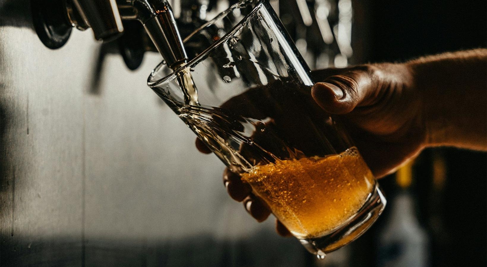 Bustling community with plenty of dining choices someone pouring a glass of beer
