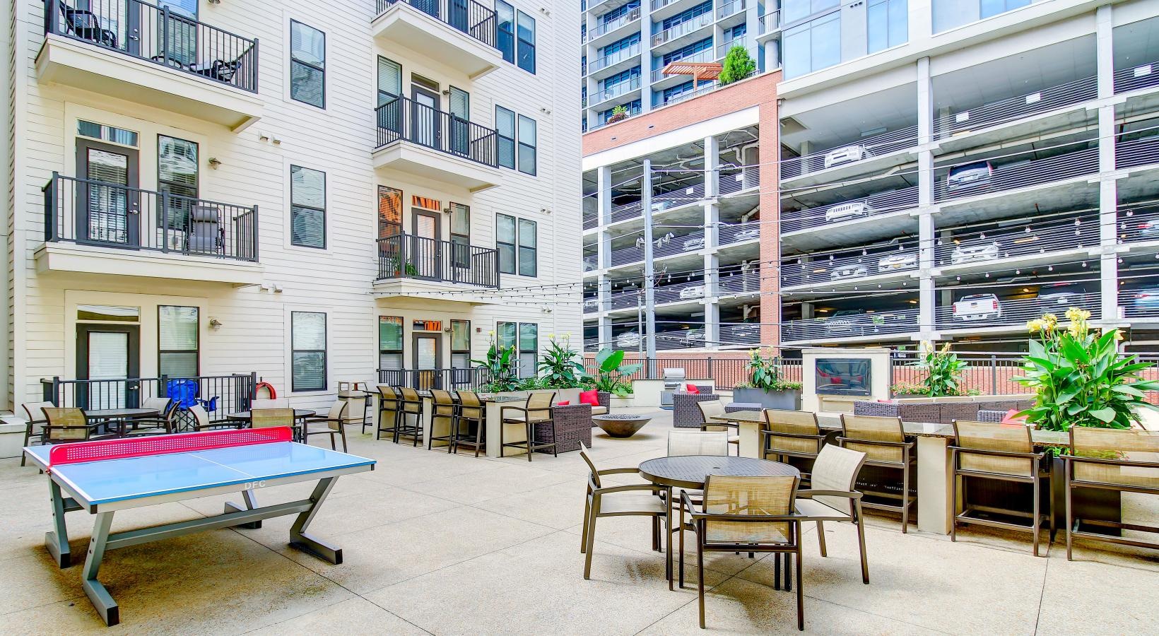 Find your perfect fit at Artisan on 18th a courtyard with tables and chairs