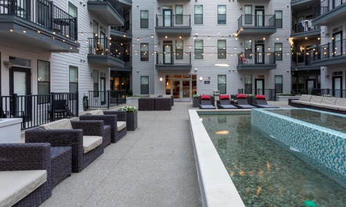 a pool in a courtyard between buildings