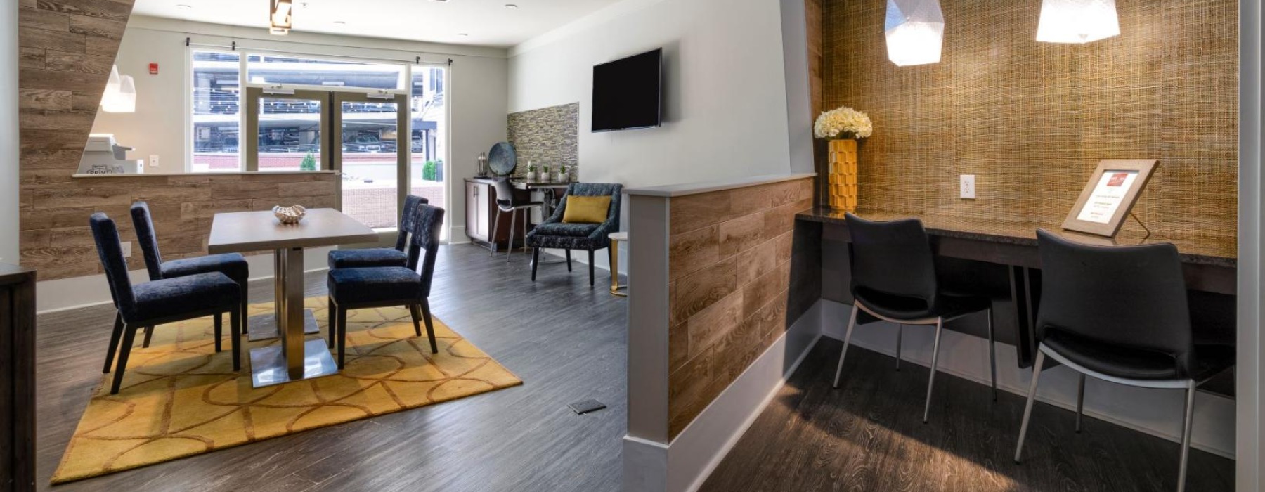 a room with a table chairs and a tv