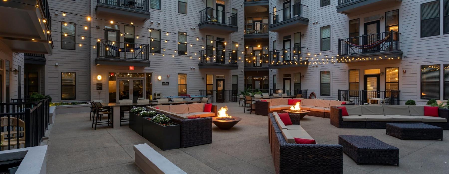 a courtyard with a fire pit and buildings