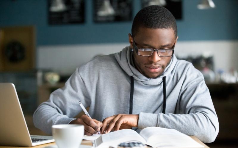 a man writing on a book