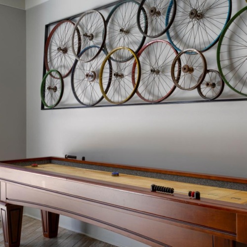 Find your perfect fit at Artisan on 18th a wall with a shuffle board next to it