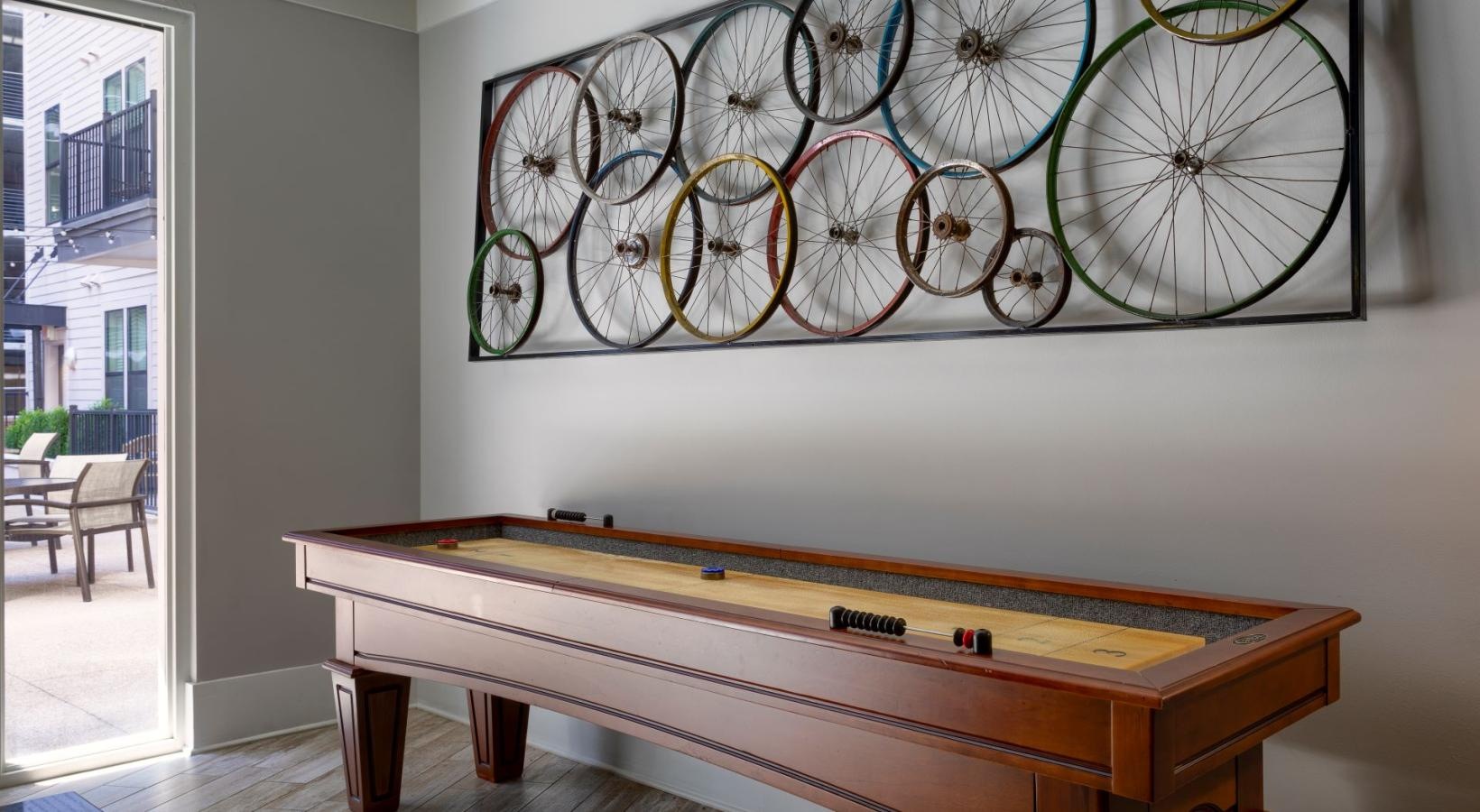 Find your perfect fit at Artisan on 18th a wall with a shuffle board next to it