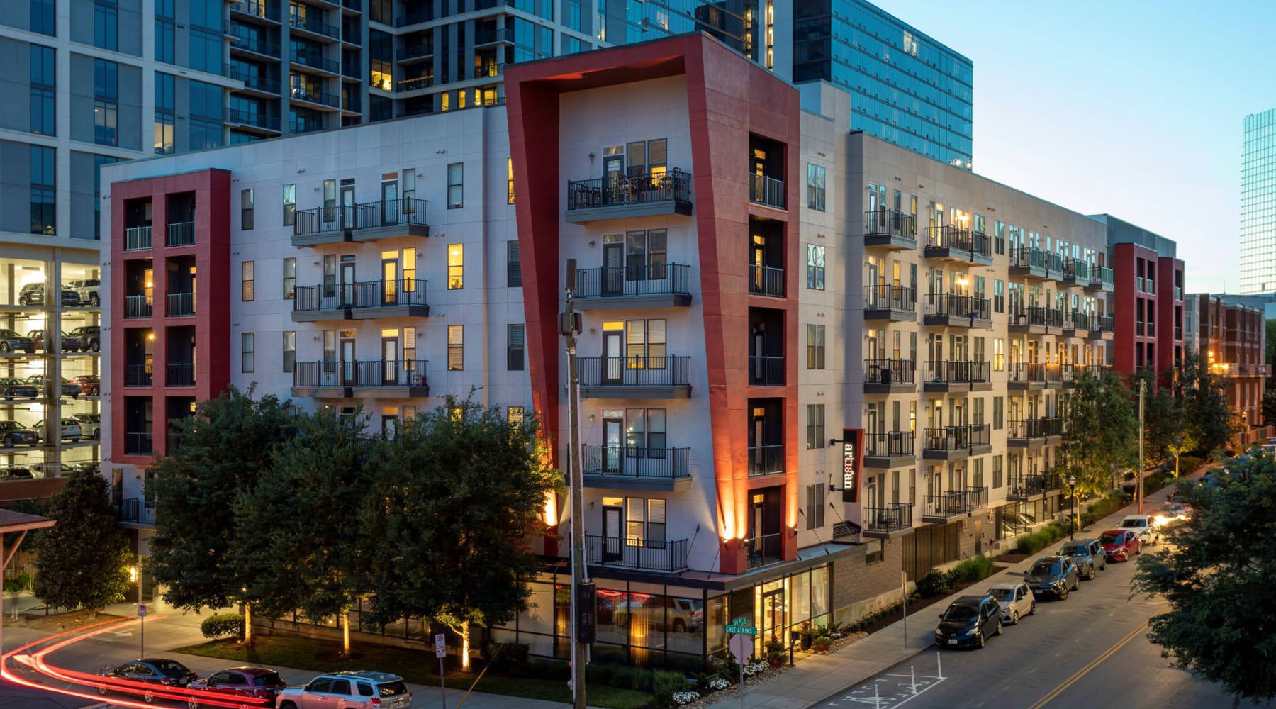 Settle into comfort at Artisan on 18th a street with cars and buildings along it