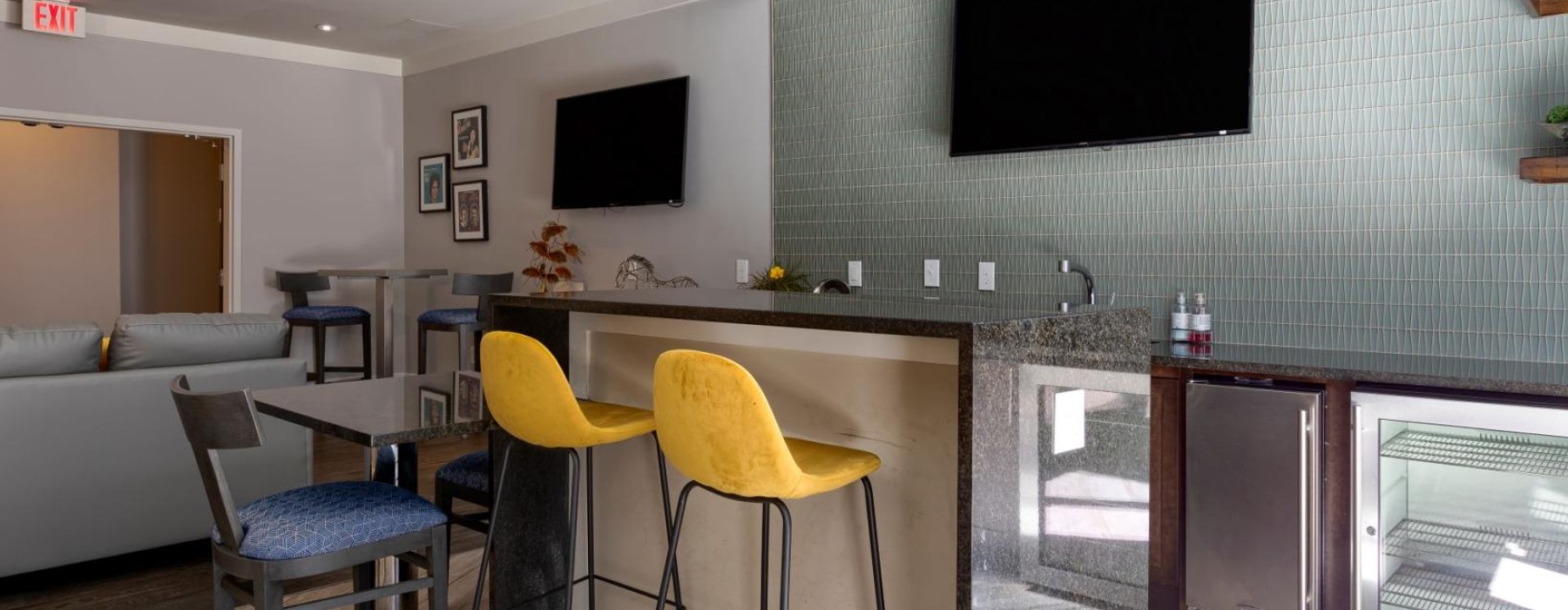 a room with a tv and chairs