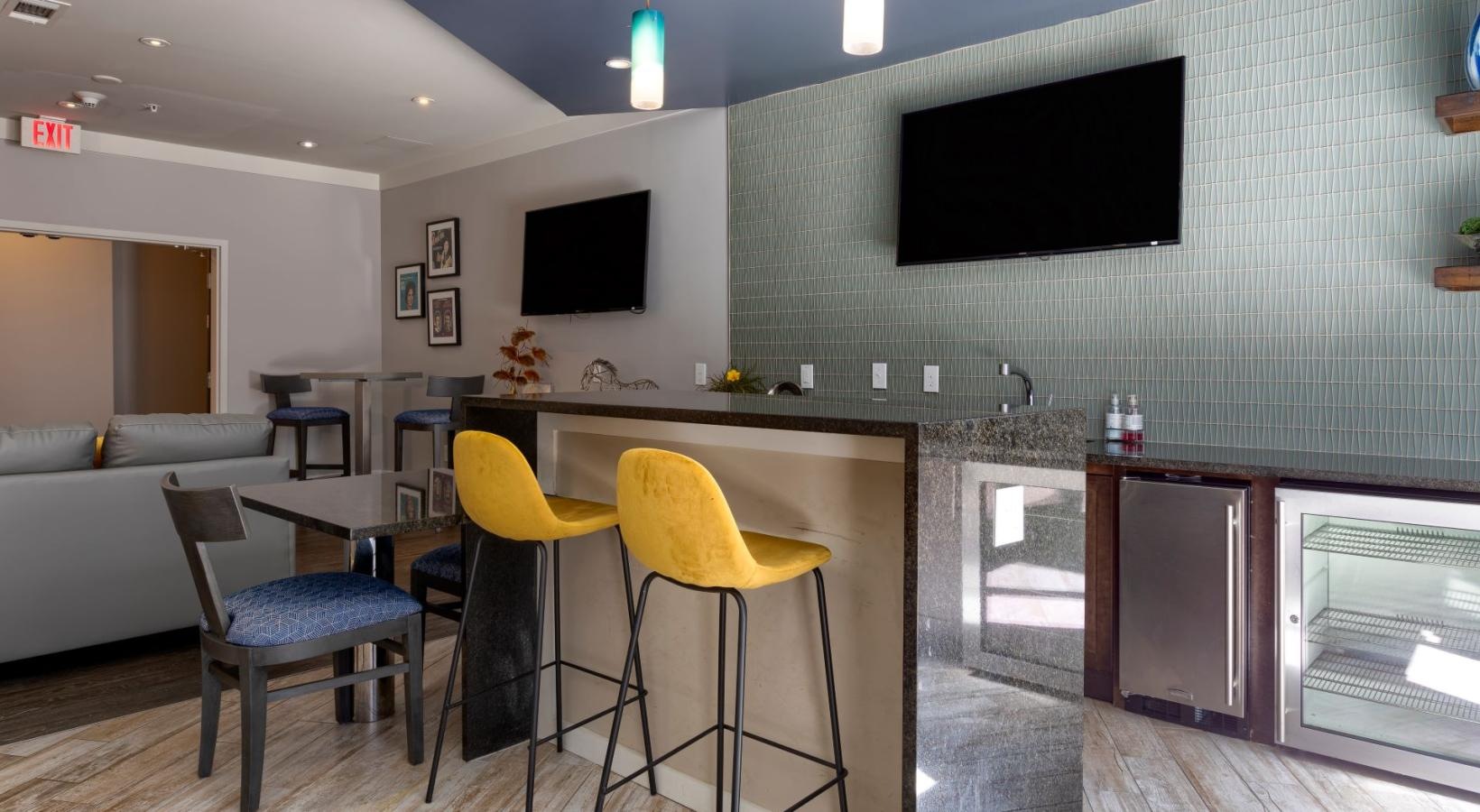 Find your perfect fit at Artisan on 18th a room with a tv and chairs