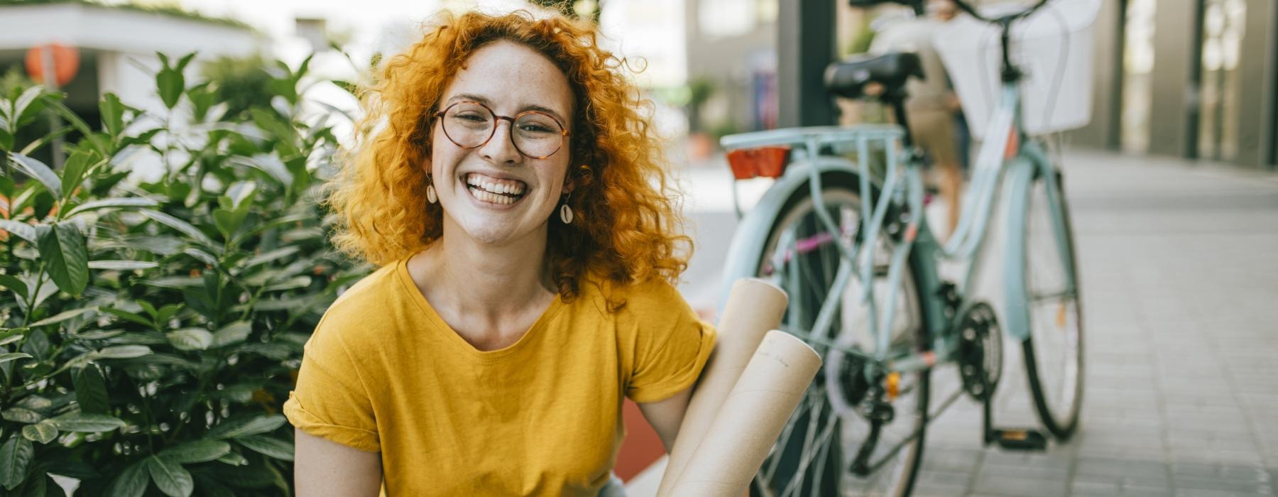 a person sitting on a sidewalk