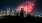 a crowd of people watching fireworks