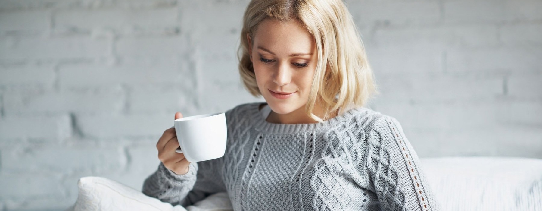 a person holding a cup of coffee