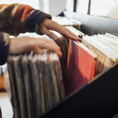Close to the center of everything a person looking at records