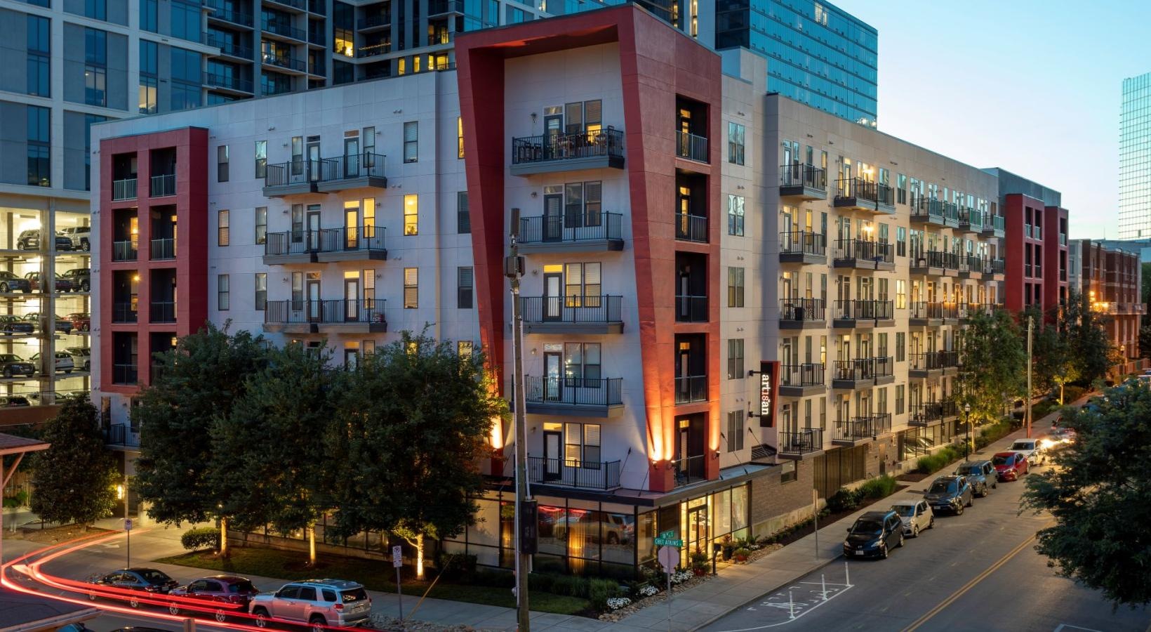 Settle into comfort at Artisan on 18th a street with cars and buildings along it